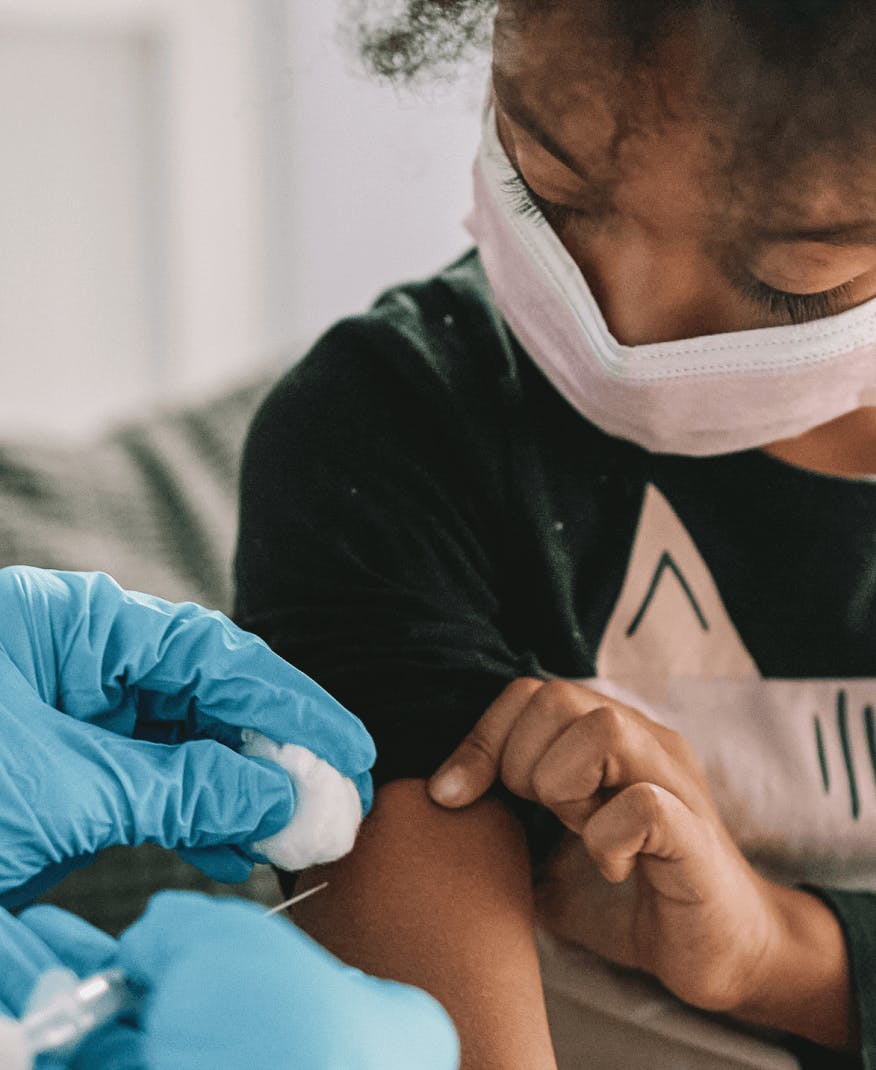 A kid is being brave while getting a vaccine.